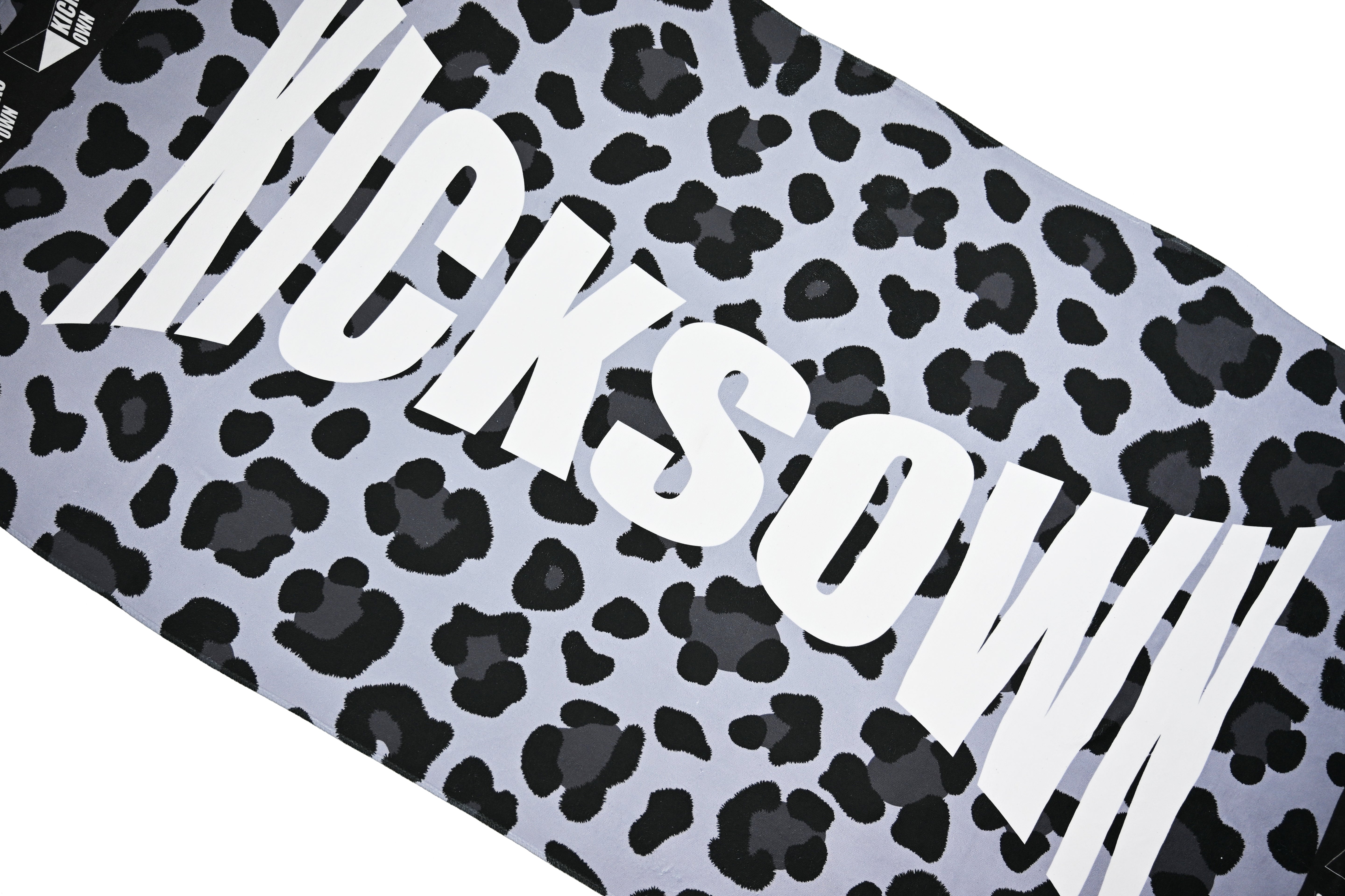 Leopard print pattern with 'KICKSOWN' text on a gray background