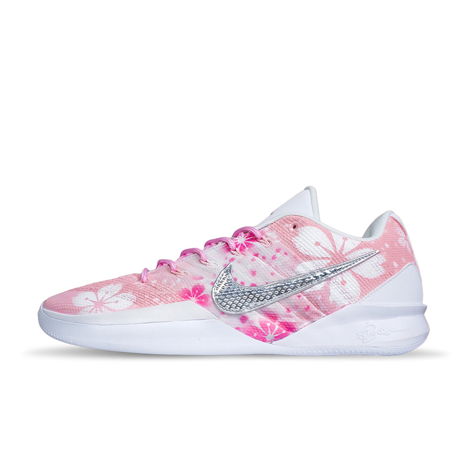 Customized Nike Sabrina 3 'Petal Pink' basketball shoe, side view showing pink floral artwork, a textured silver Swoosh and white sole.
