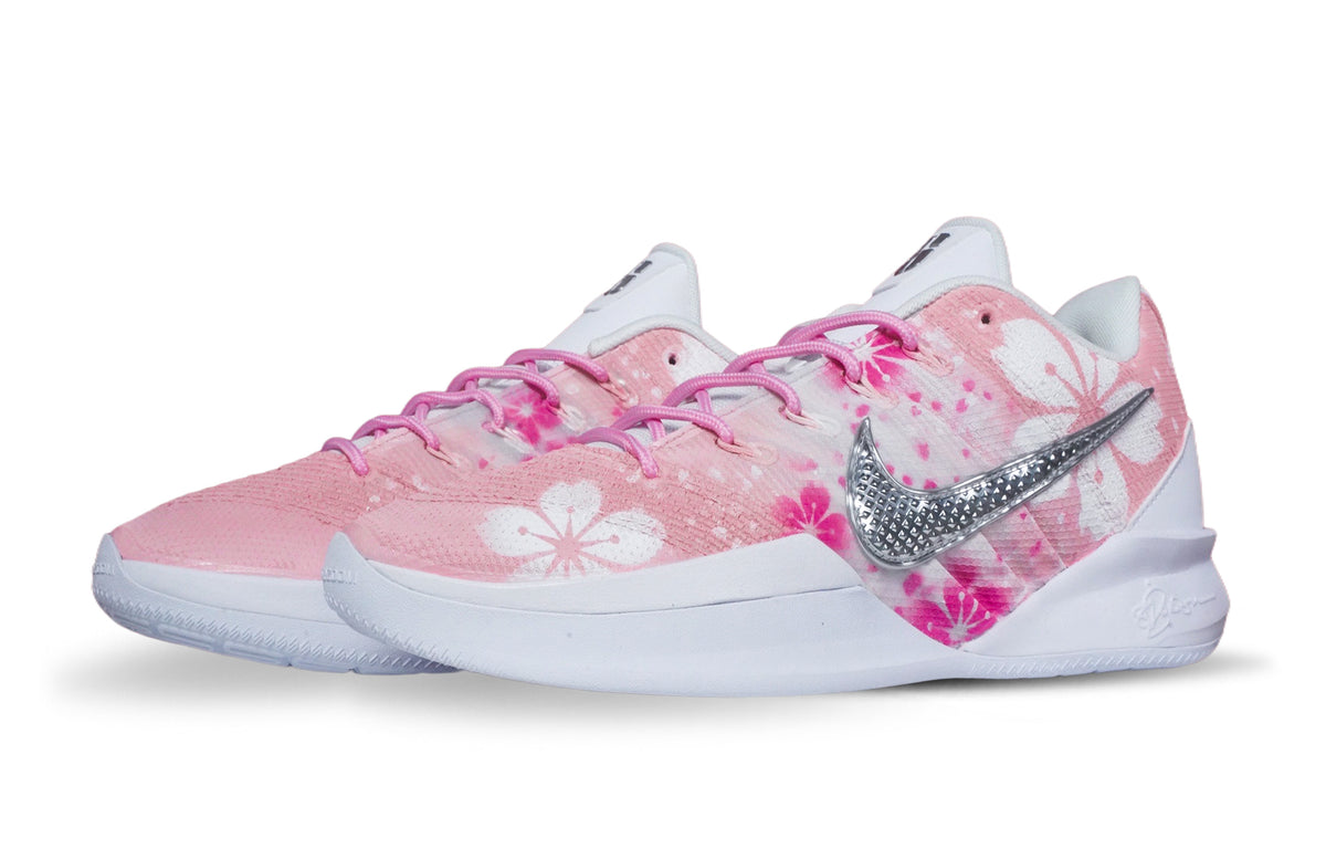 Pair of customized Nike Sabrina 3 'Petal Pink' basketball shoes with pink floral uppers, silver Swooshes and white soles, angled front view.