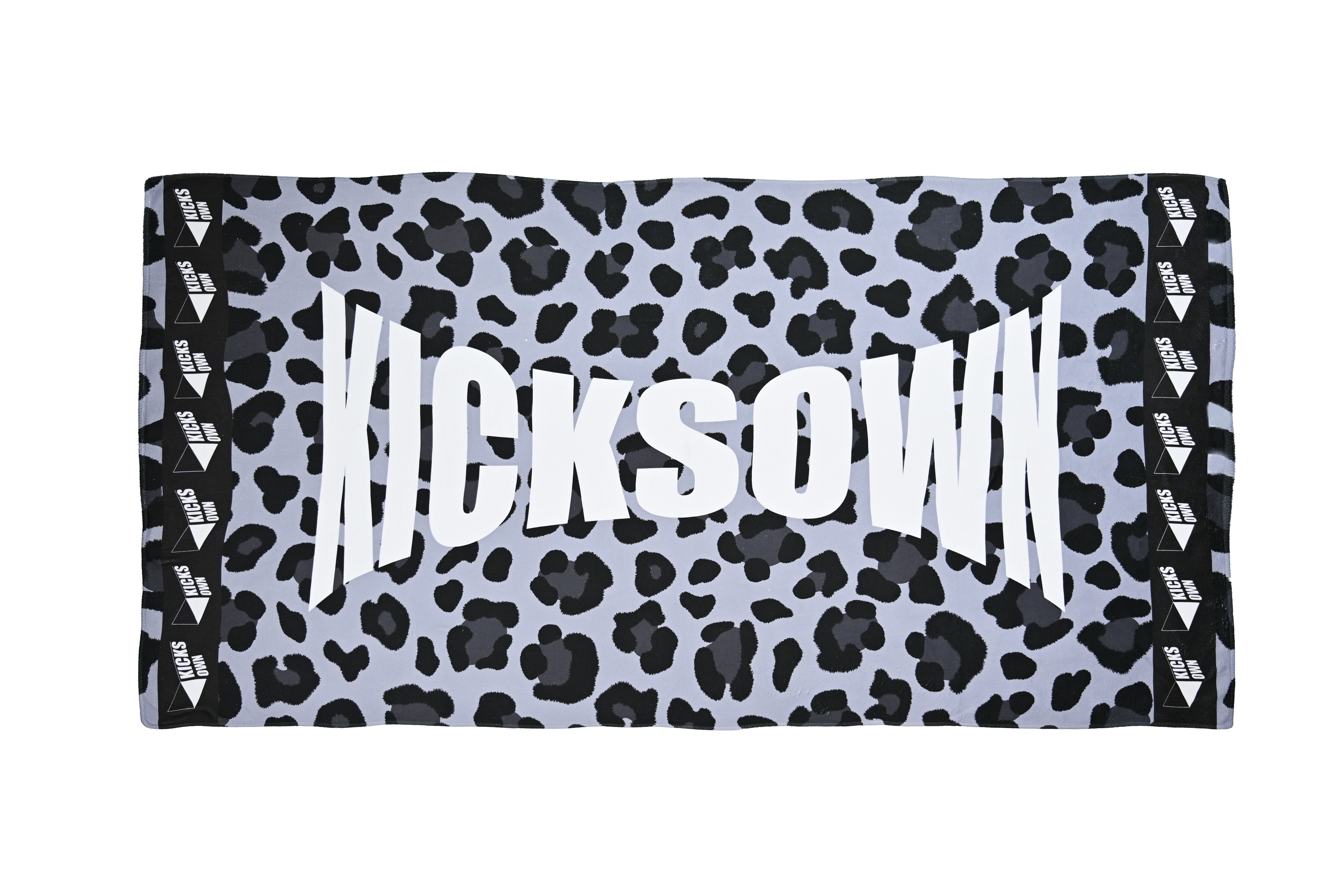 Towel with black and white leopard print pattern and 'KICKSOWN branding on a white background